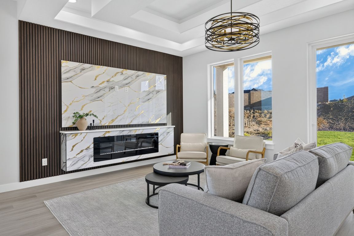 Living room interior with a marble fireplace and dark wood accent wall at 3467 Allison Way, Richland, Washington